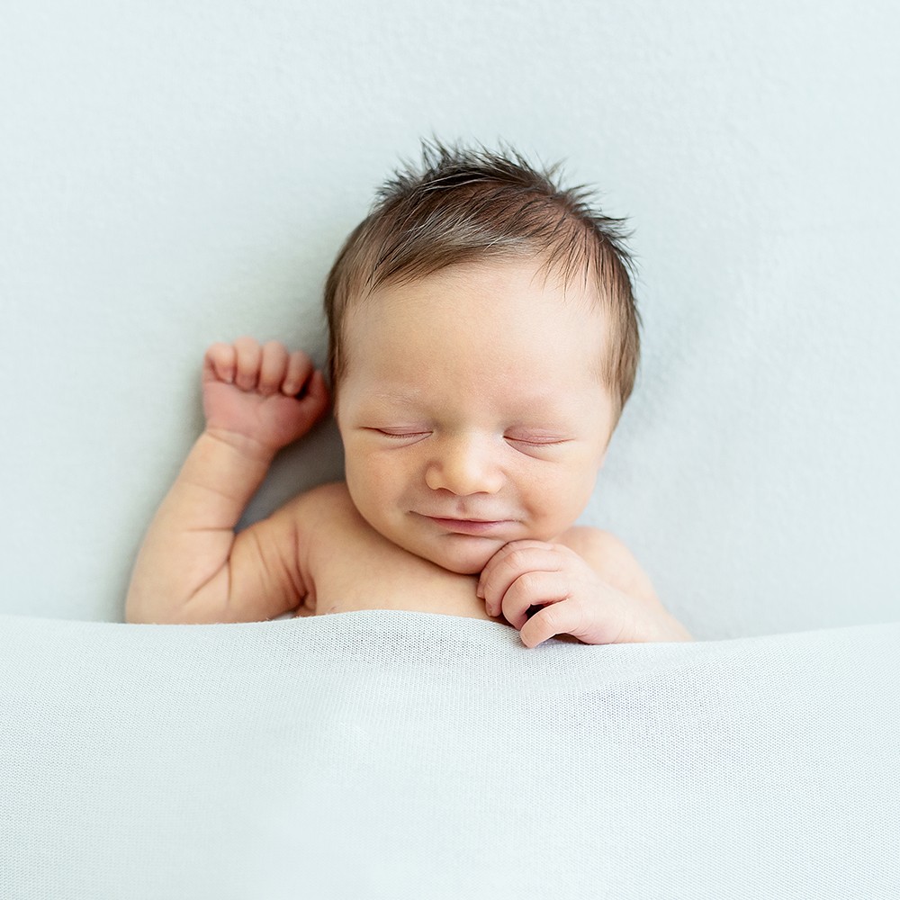 "Sleepy Smiles" Newborn Baby Photo Studio Session | Warwick, RI - smiling in blanket