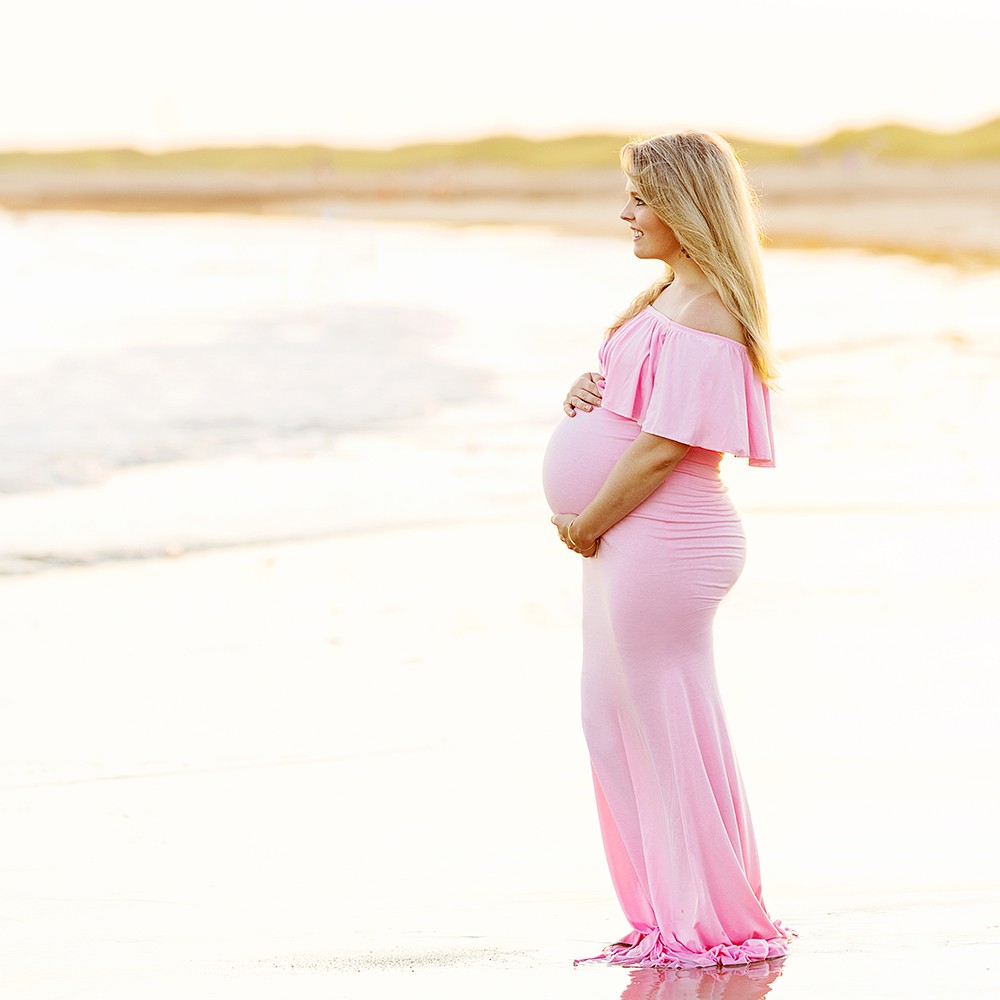 Maternity Photography and Beach Photo Session | Watch Hill, Napatree Point, Westerly, RI - Mother-to-be holding belly on edge of beach
