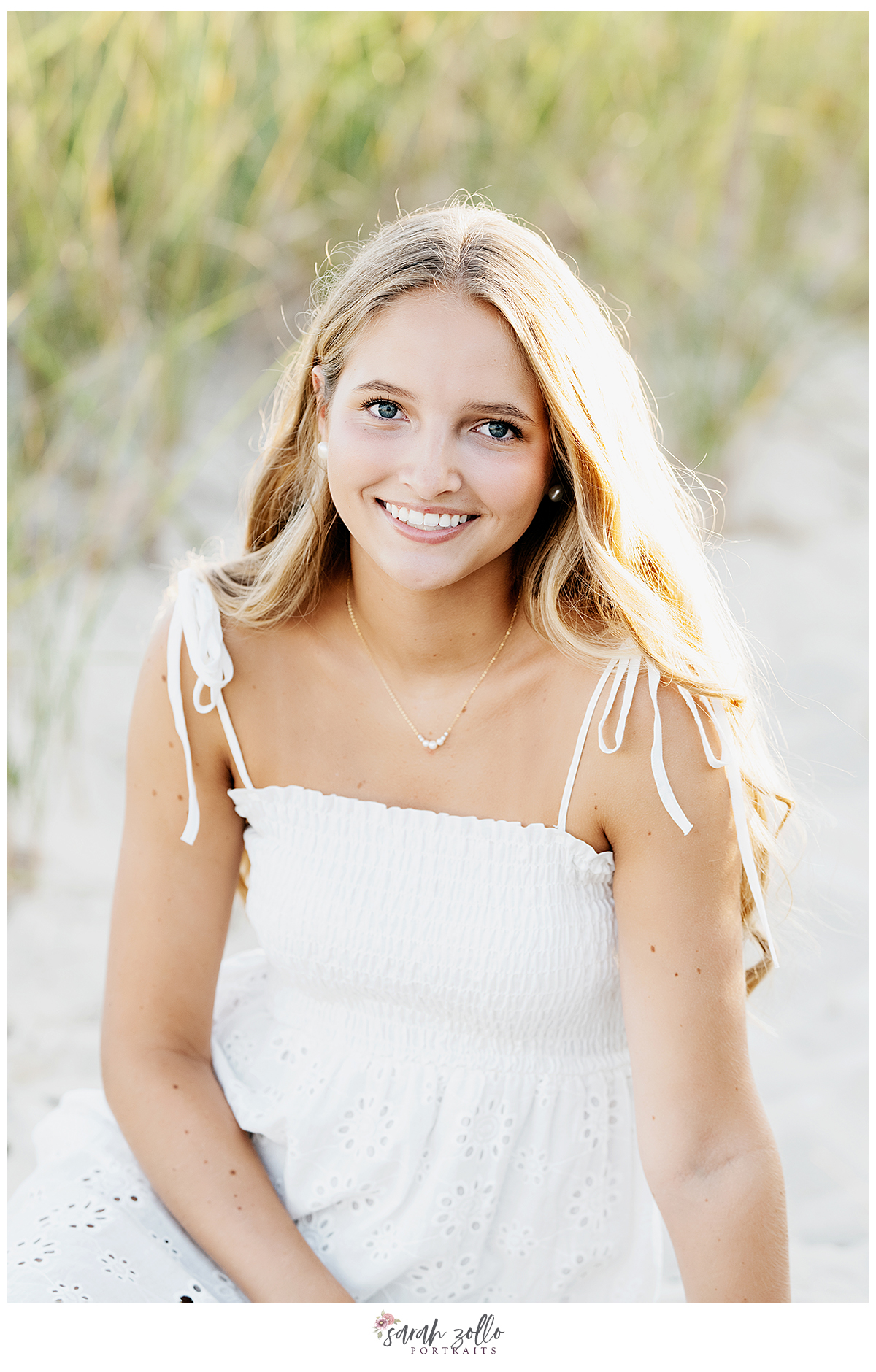 high school senior portraits Rhode Island Connecticut girl in sand wearing white dress