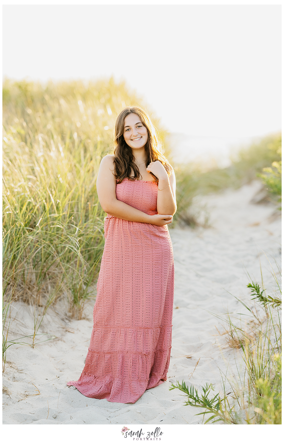 high school senior portraits Rhode Island Connecticut girl in pink dress on beach at sunset