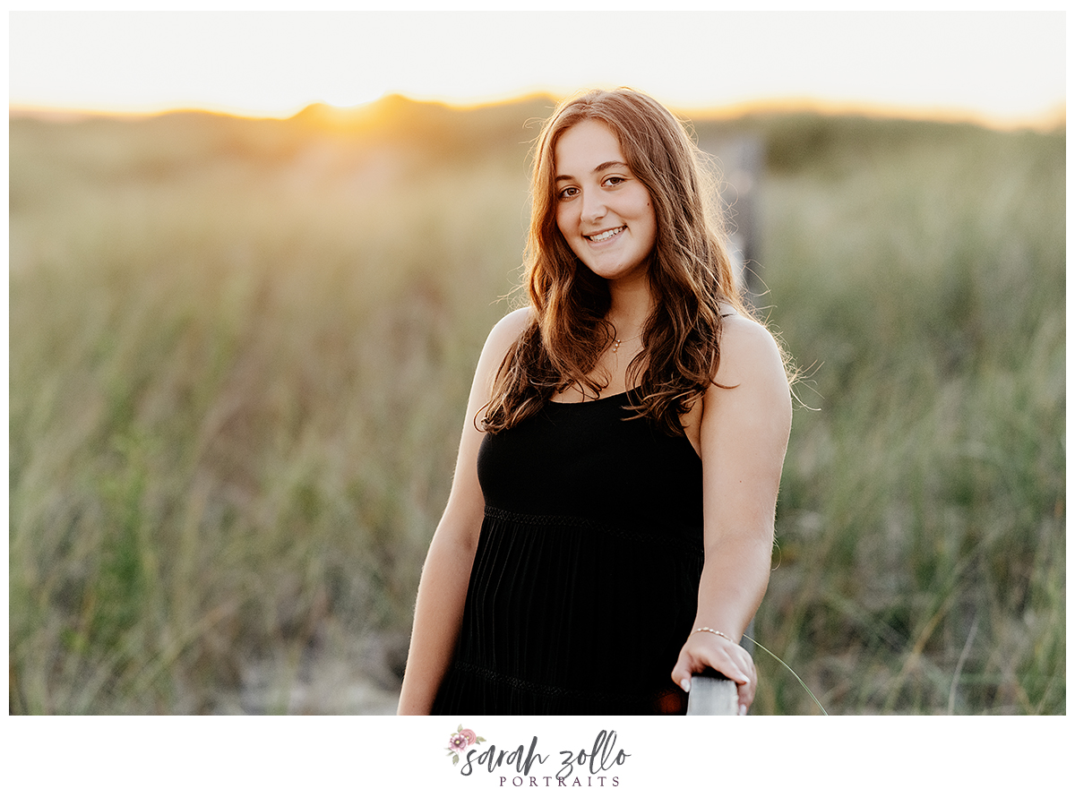 high school senior portraits Rhode Island Connecticut golden hour girl in black dress in sea grass