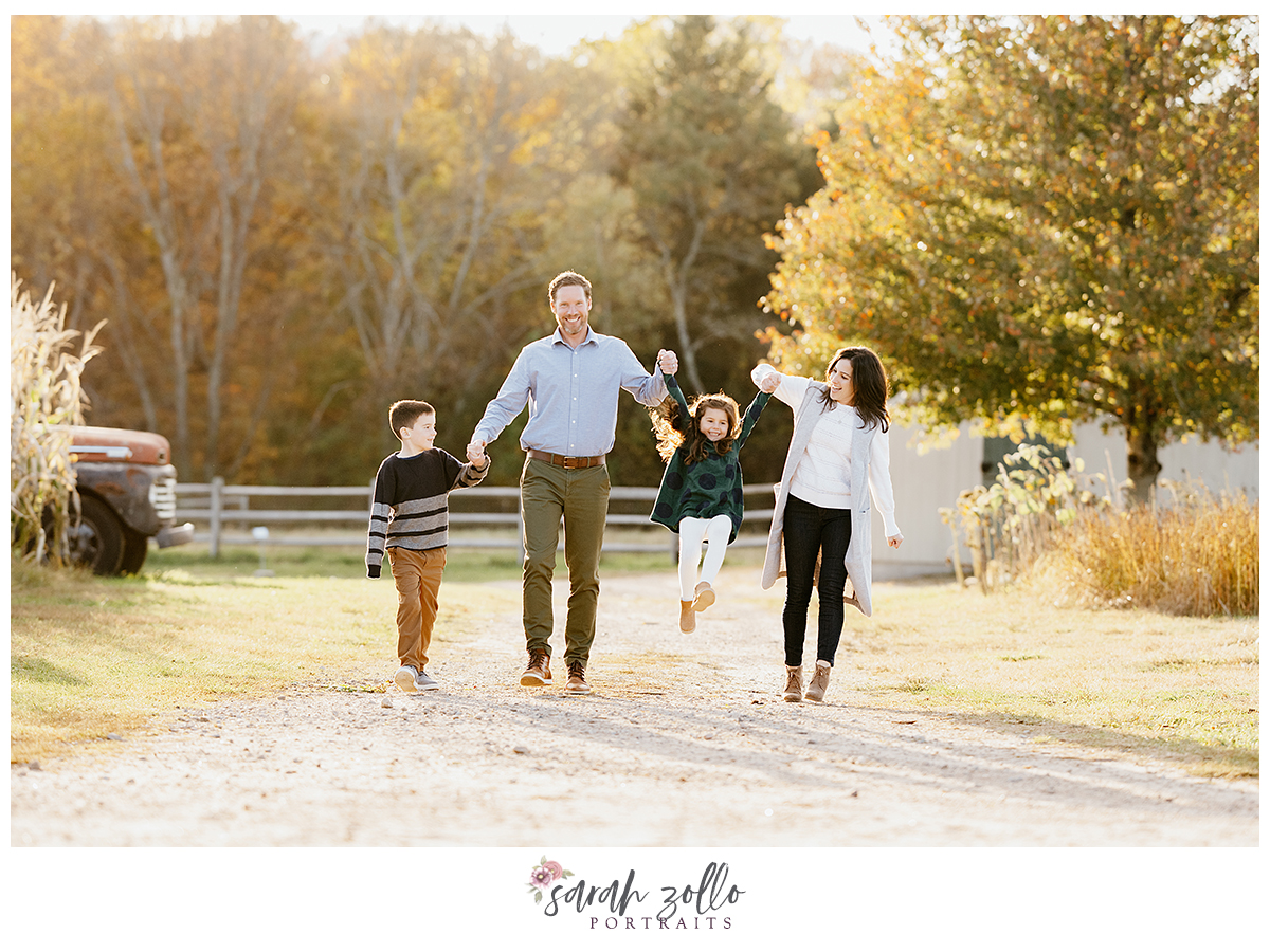 fall family photography sessions at the farmers daughter ri walking mom and dad swing little girl