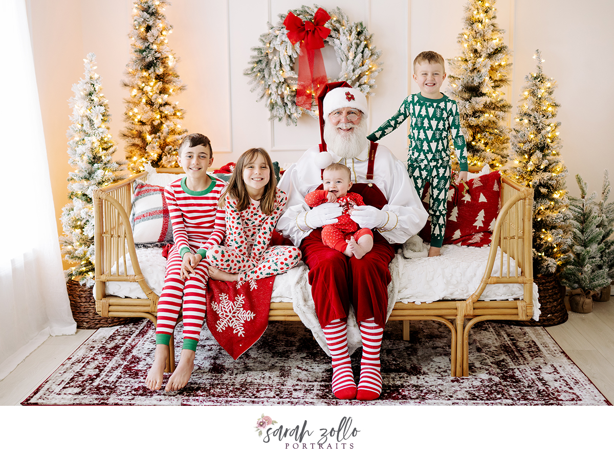 children in pajamas with santa photoshoot holiday mini session Christmas trees with lights