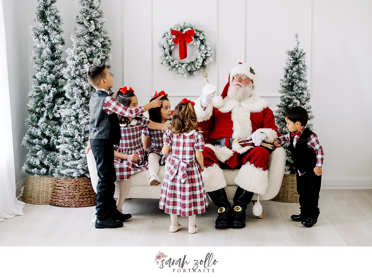 children gathered around santa Christmas trees holiday mini session